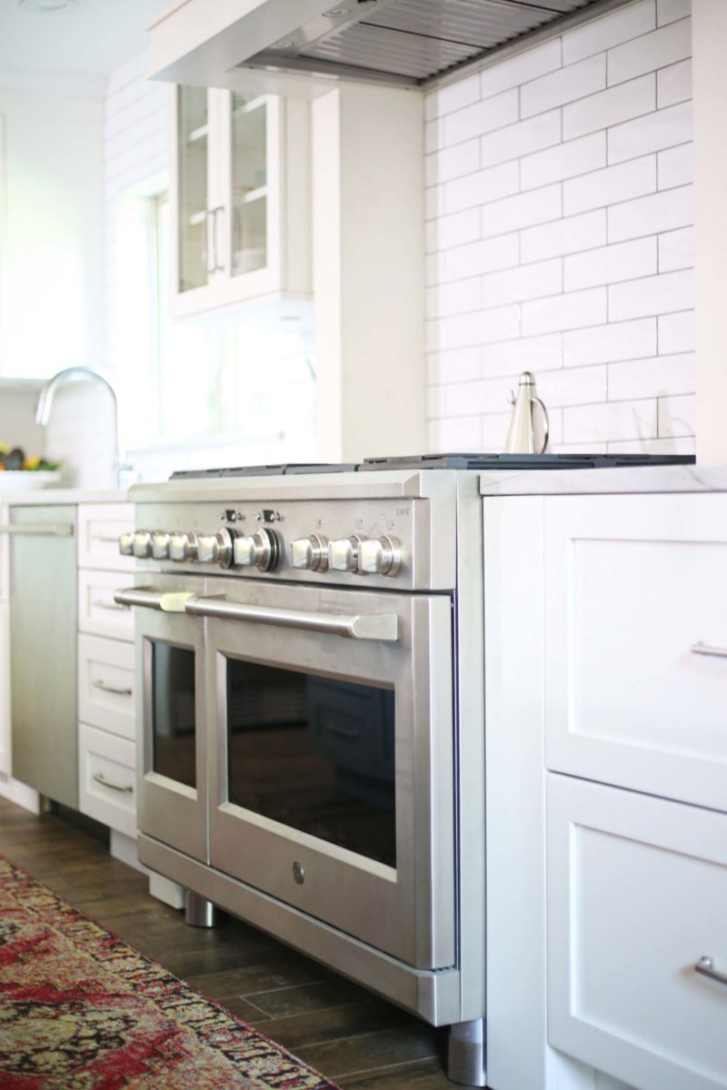Gas kitchen range, vent hood, white kitchen cabinet storage, subway tile backsplash Kitchen Ideas Tulsa kitchen remodel