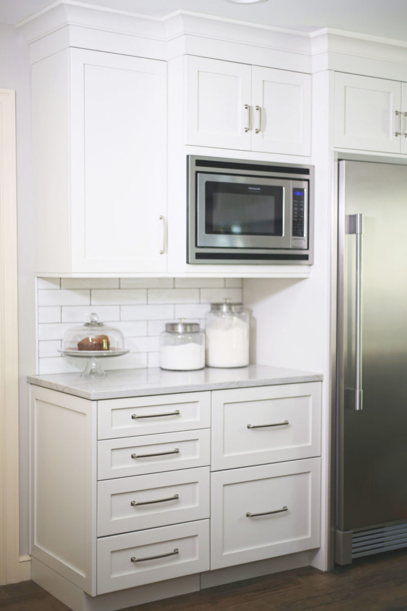 Microwave cabinet kitchen storage, Sub-Zero stainless refrigerator freezer, panel drawer refrigerator, white kitchen cabinet storage Kitchen Ideas Tulsa kitchen remodel