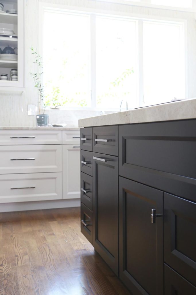 White and rich dark brown base cabinet storage, white counter tops and refinished wood flooring.