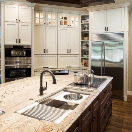 Tulsa kitchen remodel island, marble counters, Galley Workstation, Wolf induction cooktop, tall pantry storage, Wolf double ovens, Sub-Zero freezer refrigerator, open shelves Tulsa kitchen design