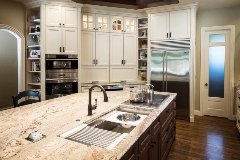 Tulsa kitchen remodel island, marble counters, Galley Workstation, Wolf induction cooktop, tall pantry storage, Wolf double ovens, Sub-Zero freezer refrigerator, open shelves Tulsa kitchen design
