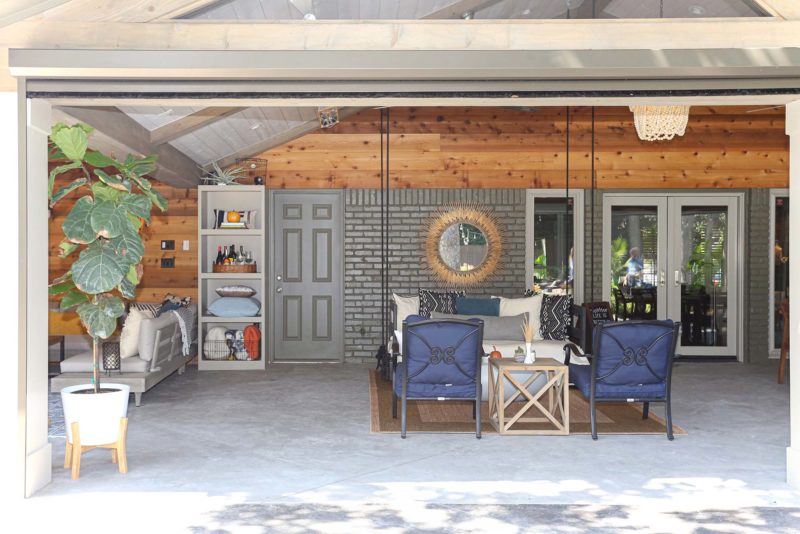 Open spacious Tulsa patio design and remodel with living area including concrete flooring, vaulted ceiling and outdoor furniture