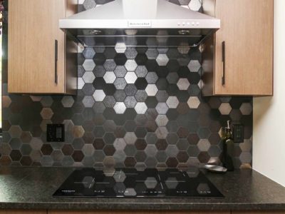 Base wall cabinet storage with stainless canopy vent hood, decorative tile backsplash and induction cooktop Kitchen Ideas Tulsa kitchen remodel
