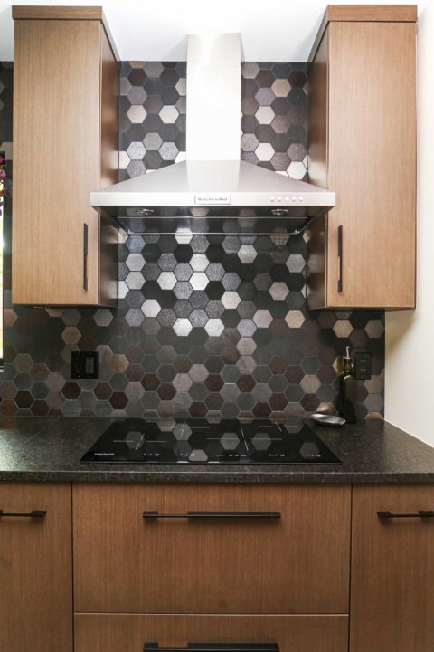 Base wall cabinet storage with stainless canopy vent hood, decorative tile backsplash and induction cooktop Kitchen Ideas Tulsa kitchen remodel