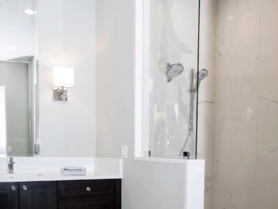 Modern Tulsa bathroom shower design and remodel walk-in shower with glass door and vanity cabinet storage
