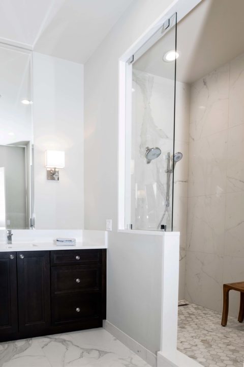 Modern Tulsa bathroom shower design and remodel walk-in shower with glass door and vanity cabinet storage