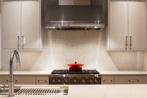 Tulsa kitchen professional range vent hood cooking space ceramic tile backsplash white flat panel cabinet storage Tulsa kitchen remodel
