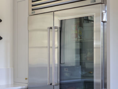Sub-Zero refrigerator freezer and white kitchen cabinet storage, professional appliances Tulsa kitchen remodel