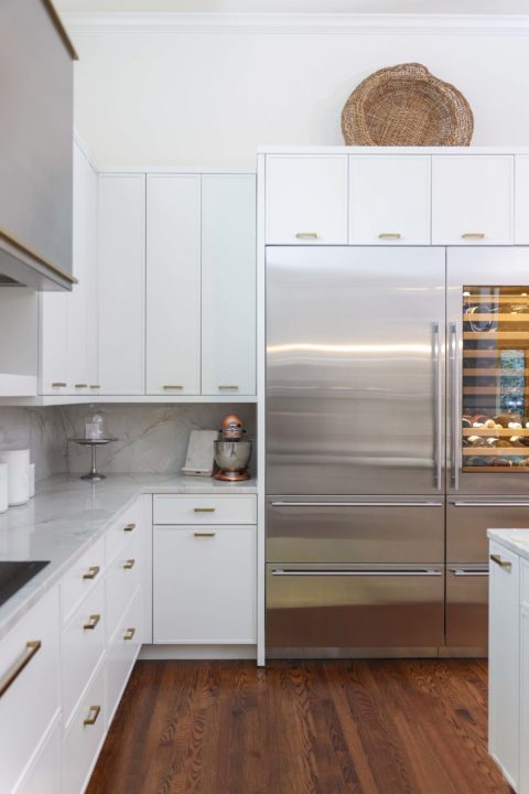 Sub-Zero tall refrigerator and wine with white cabinet base and wall storage, wood flooring Kitchen Ideas Tulsa kitchen remodel