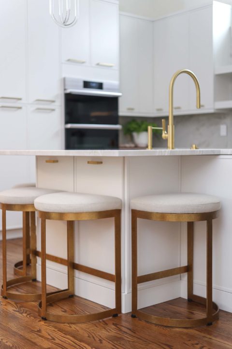 Under counter island storage and seating, Galley Workstation Tap faucet, white counter, white kitchen cabinet storage Kitchen Ideas Tulsa kitchen remodel