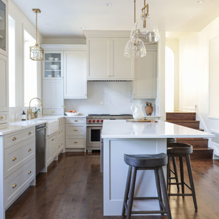 White kitchen remodel with island seating, pendant lighting, farmhouse apron-sink, Wolf gas range, drawer door storage kitchen ideas Tulsa kitchen designer