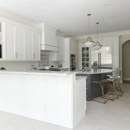 Kitchen peninsula, cabinet storage, large island with pendant lights, seating, decorative hood, rangetop, Jenn-air and Kitchenaid appliances, arched opening Kitchen Ideas Tulsa kitchen design remodel