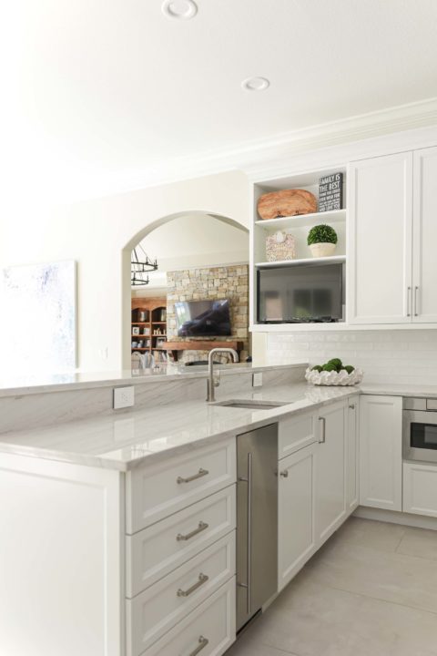 Kitchen peninsula white cabinets, undercounter ice maker, bar sink, subway tile backsplash, large crown molding Kitchen Ideas Tulsa kitchen remodel