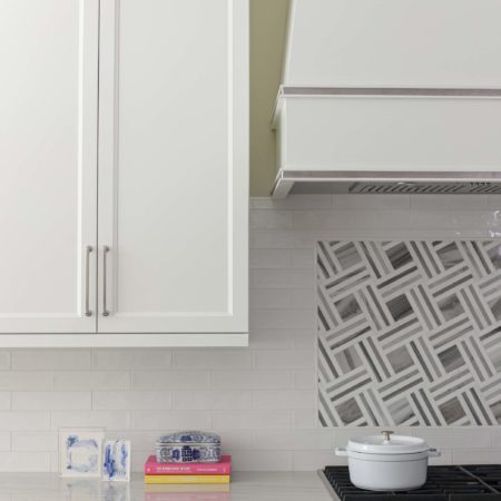 Professional kitchen rangetop with subway tile, decorative vent hood, white cabinet storage Kitchen Ideas Tulsa kitchen design remodel
