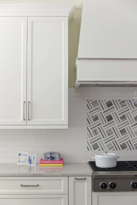 Professional kitchen rangetop with subway tile, decorative vent hood, white cabinet storage Kitchen Ideas Tulsa kitchen design remodel