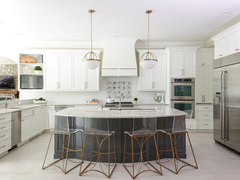 Tulsa kitchen design and remodel featuring extensive white kitchen storage, a large island with seating, pendant lights, and JennAir and KitchenAid appliances.