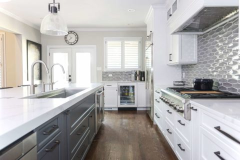 Gray white kitchen cabinets, island, Galley Workstation, pendants, quartz counters, wood floors, rangetop, tile backsplash Tulsa kitchen remodel