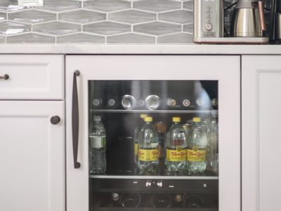 Kitchen beverage storage space, white cabinet storage, decorative tile backsplash, quartz counter Tulsa kitchen design and remodel