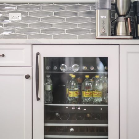 Kitchen beverage storage space, white cabinet storage, decorative tile backsplash, quartz counter Tulsa kitchen design and remodel