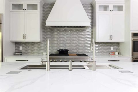 Tuxedo kitchen Galley Workstation, gas rangetop, vent hood, decorative tile backsplash Tulsa kitchen design and remodel