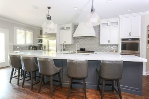 Tulsa tuxedo kitchen cabinets, island seating, pendants, Galley Workstation, stainless refrigerator, double ovens, wood floors, decorative backsplash Tulsa kitchen remodel