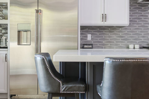 Two tone kitchen cabinets, large island seating, pendants, stainless appliances, wood floors, decorative backsplash Tulsa kitchen design and remodel