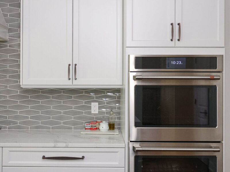 Tulsa kitchen remodel featuring white kitchen cabinets, double ovens, and extensive storage.