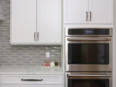 Kitchen double ovens, white kitchen cabinet storage, decorative tile backsplash, crown molding Kitchen Ideas Tulsa kitchen remodel