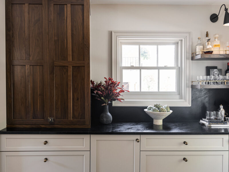 Tulsa kitchen remodel featuring black countertops, base cabinet storage, and decorative floating shelves.