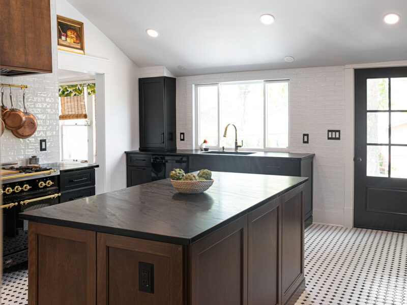 Tulsa kitchen design and remodel featuring a French range, a kitchen island with built-in cabinet storage, and a sink workstation.