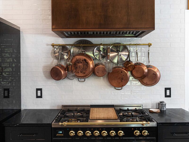 Tulsa kitchen design and remodel featuring a french range, a plate rack, and a glossy white subway tile backsplash.