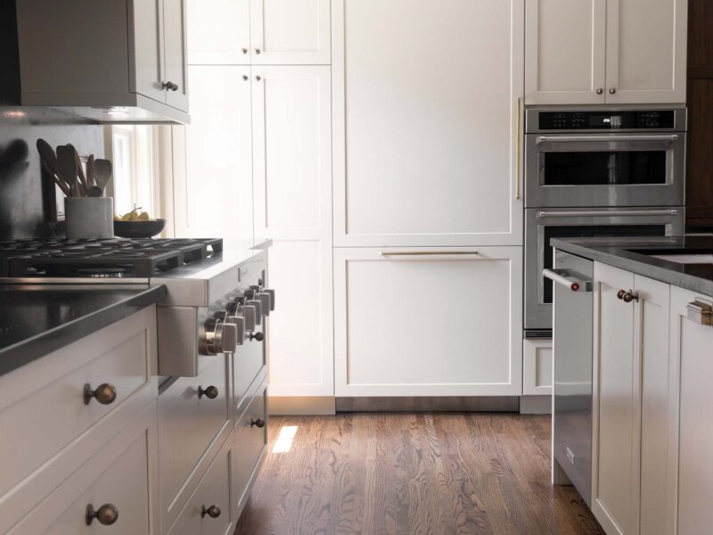 Tulsa kitchen remodel featuring tall cabinet storage, a panel-front refrigerator, double ovens, and a gas rangetop, along with extensive kitchen drawer storage.