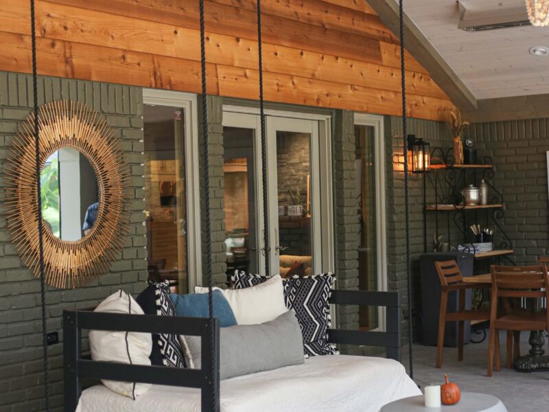 Spacious Tulsa patio featuring entry door access, comfortable outdoor furniture, dramatic vaulted ceiling, and ceiling fan in design and remodel.