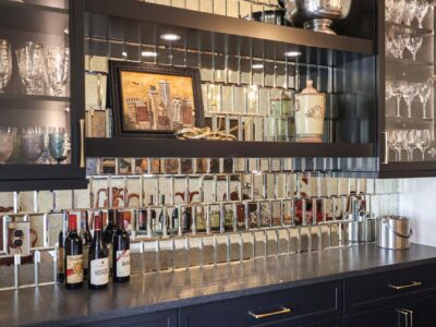Beverage bar with floating shelves and a tile backsplash.