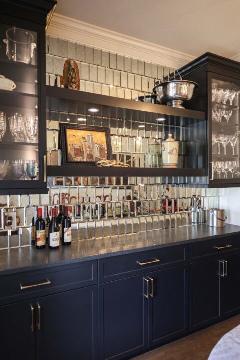 Beverage bar with floating shelves and a tile backsplash.
