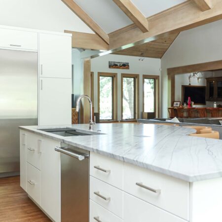Kitchen island featuring a galley sink and smart drawer storage. The design also includes a stainless steel dishwasher. Tulsa kitchen designer and remodeler.
