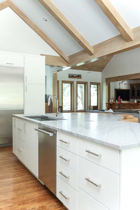 Kitchen island featuring a galley sink and smart drawer storage. The design also includes a stainless steel dishwasher. Tulsa kitchen designer and remodeler.