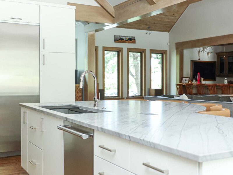 Kitchen island featuring a galley sink and smart drawer storage. The design also includes a stainless steel dishwasher. Tulsa kitchen designer and remodeler.