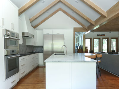Open concept kitchen design featuring vaulted ceilings, maple cabinets, a spacious island, and a galley workstation. Tulsa kitchen designer.