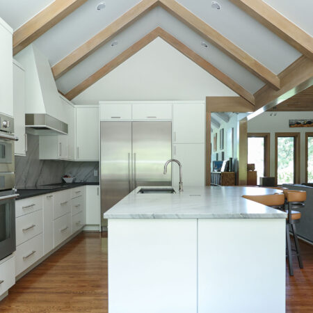 Open concept kitchen design featuring vaulted ceilings, maple cabinets, a spacious island, and a galley workstation. Tulsa kitchen designer.