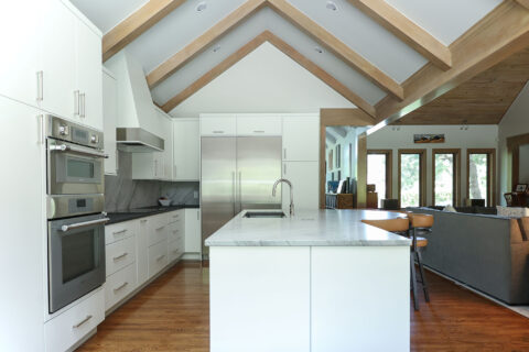 Open concept kitchen design featuring vaulted ceilings, maple cabinets, a spacious island, and a galley workstation. Tulsa kitchen designer.